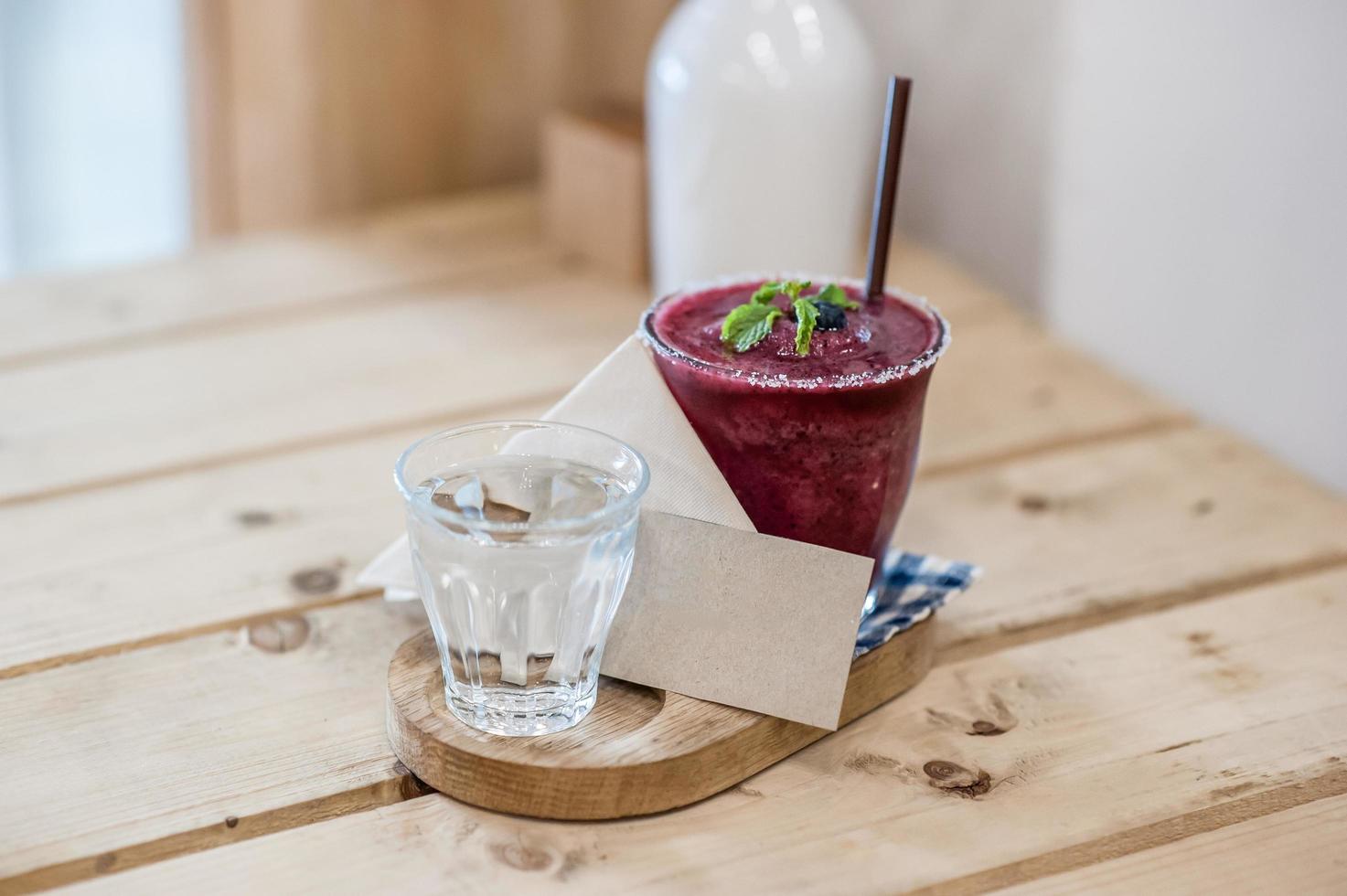 Blueberry smoothie on the table and blank card soft focus point photo