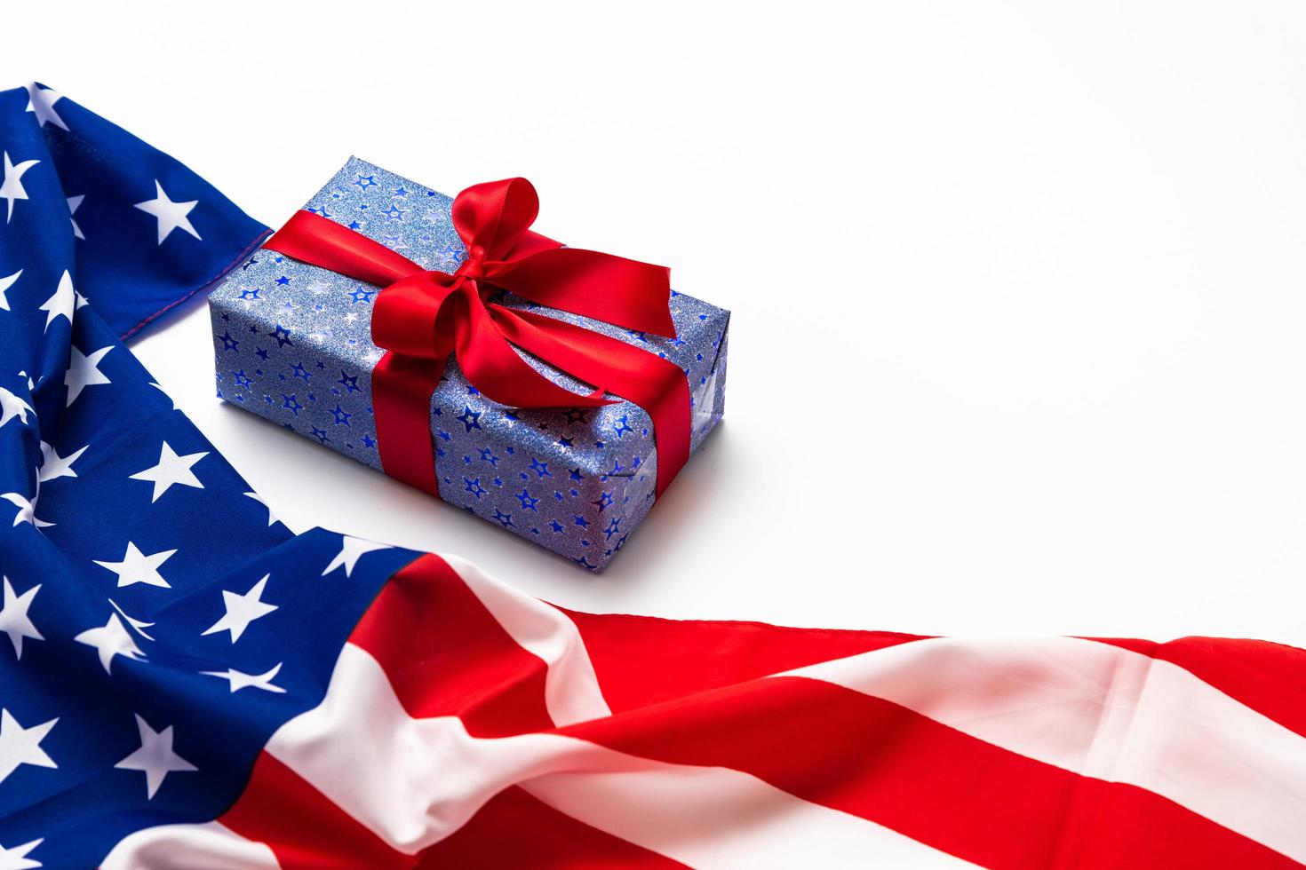 Happy Veterans Day concept. American flags with gift box against a blackboard background. November 11. photo