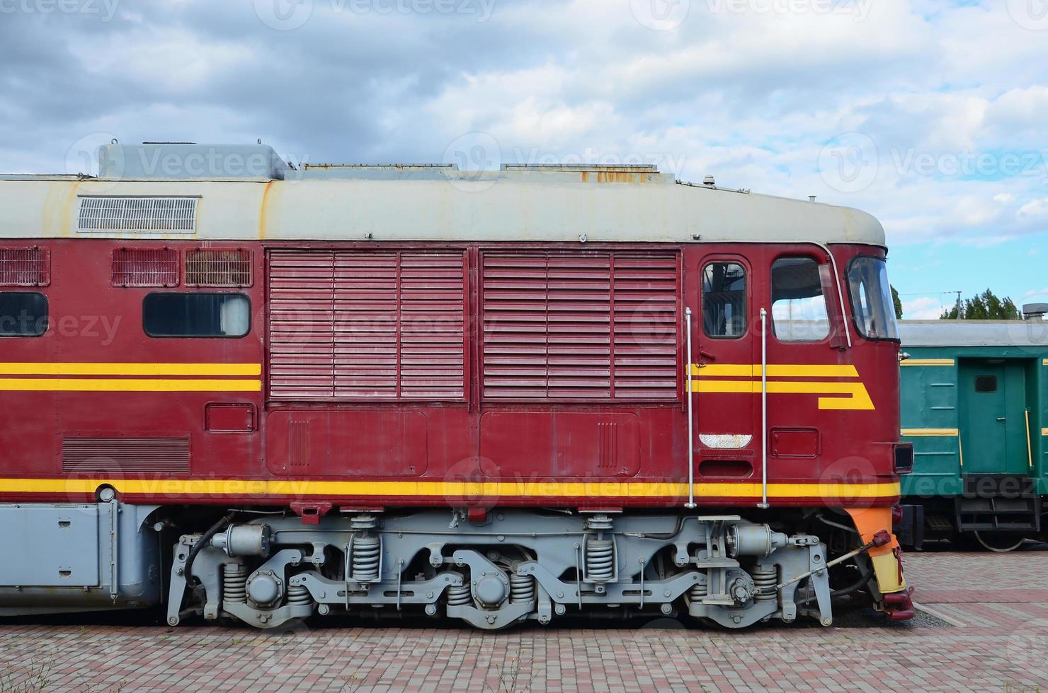 Cabin of modern Russian electric train. Side view of the head of railway train with a lot of wheels and windows in the form of portholes photo
