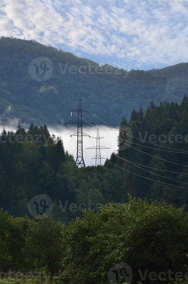 Landscape in a mountainous area. Towers with power lines in the mountains photo