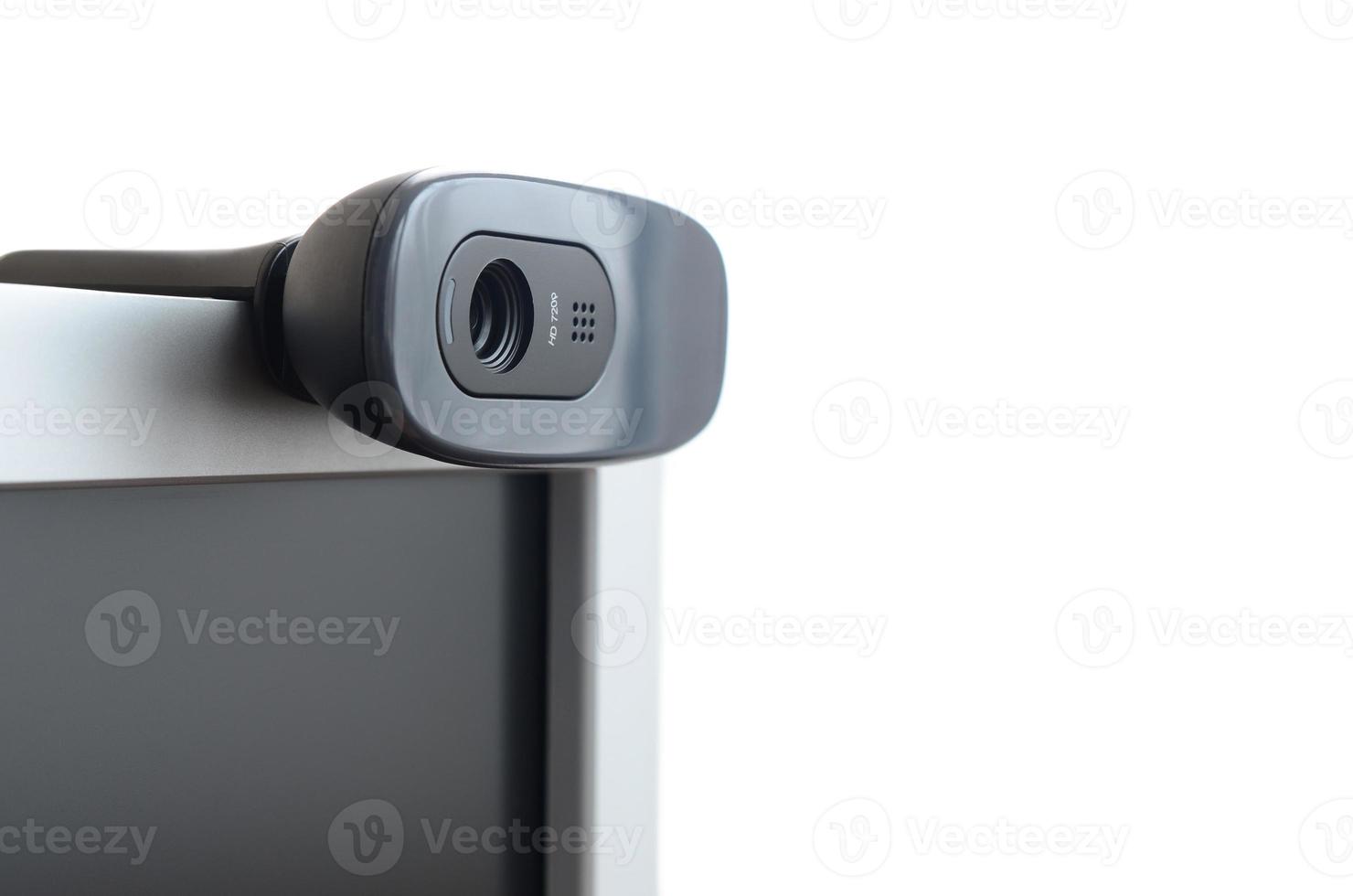 A modern web camera is installed on the body of a flat screen monitor. Device for video communication and recording of high quality video photo