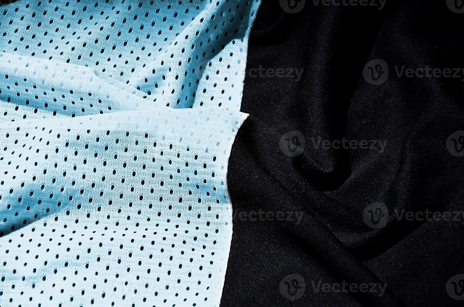 Blue sport clothing fabric texture background. Top view of light blue cloth textile surface. Bright basketball shirt. Text Space photo