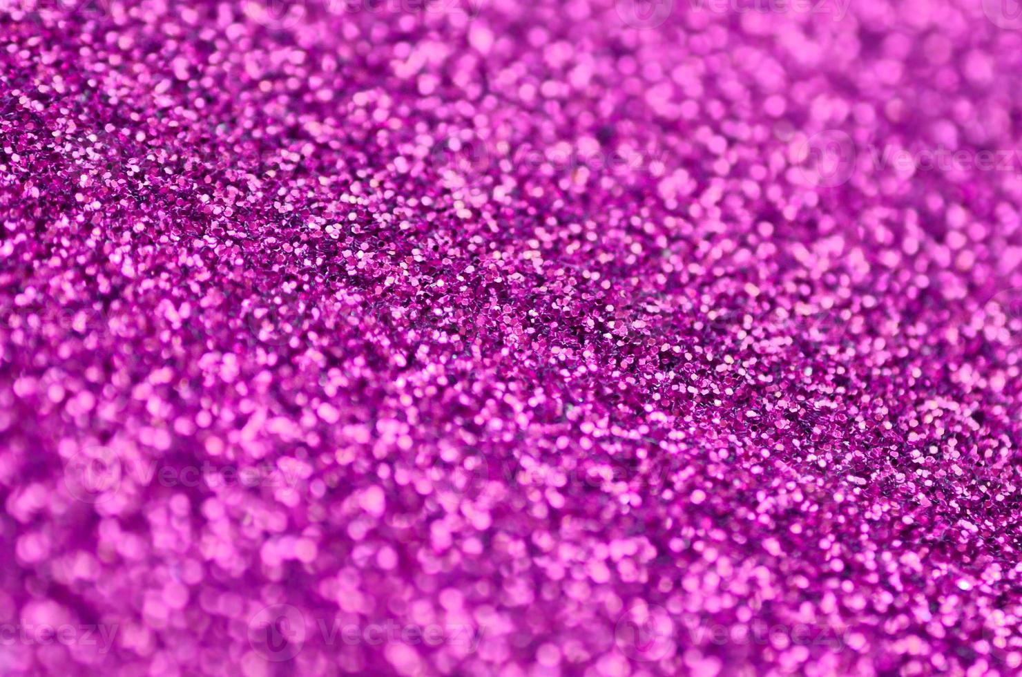 Pink decorative sequins. Background image with shiny bokeh lights from small elements photo