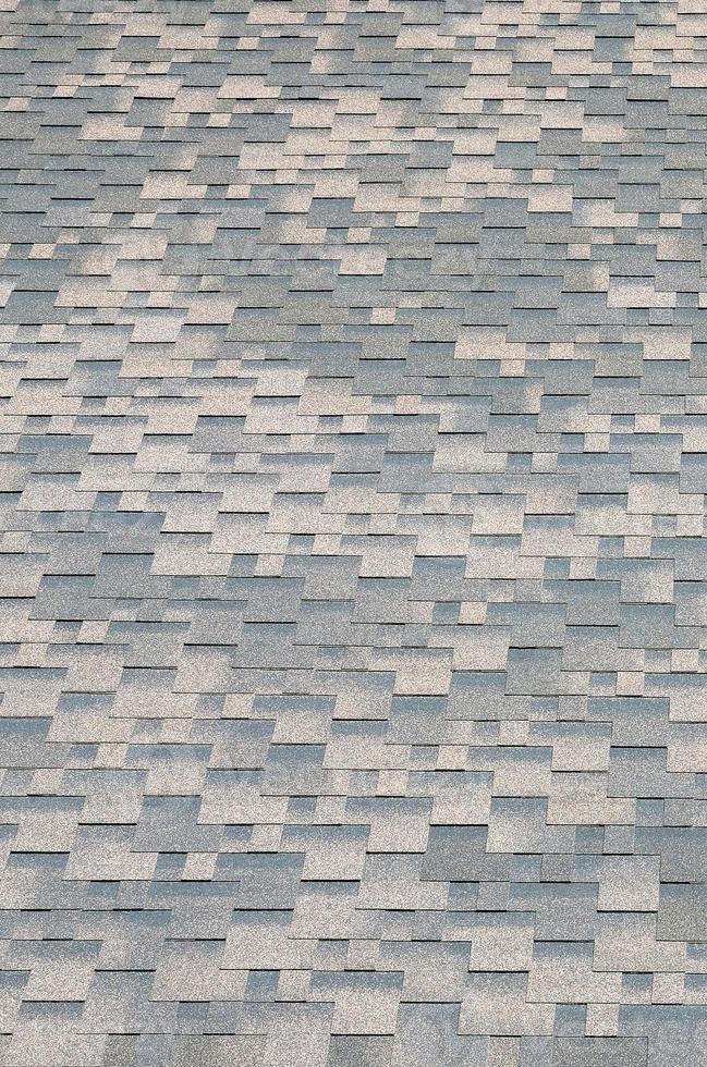 Background mosaic texture of flat roof tiles with bituminous coating photo