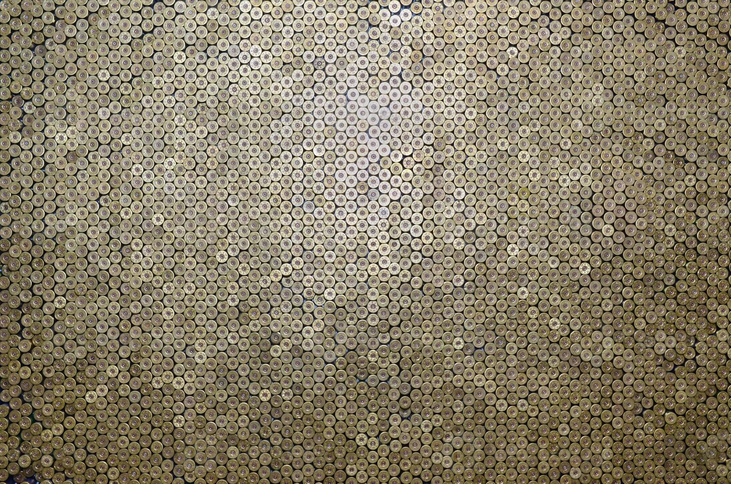 Pattern of 12 gauge cartridges for shotgun bullets. Shells for hunting rifle close up. Backdrop for shooting range or ammunition trade concepts photo