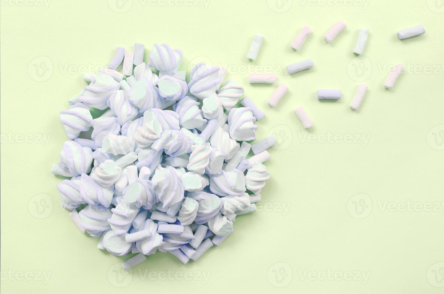 Colorful marshmallow laid out on lime paper background. pastel creative texture photo
