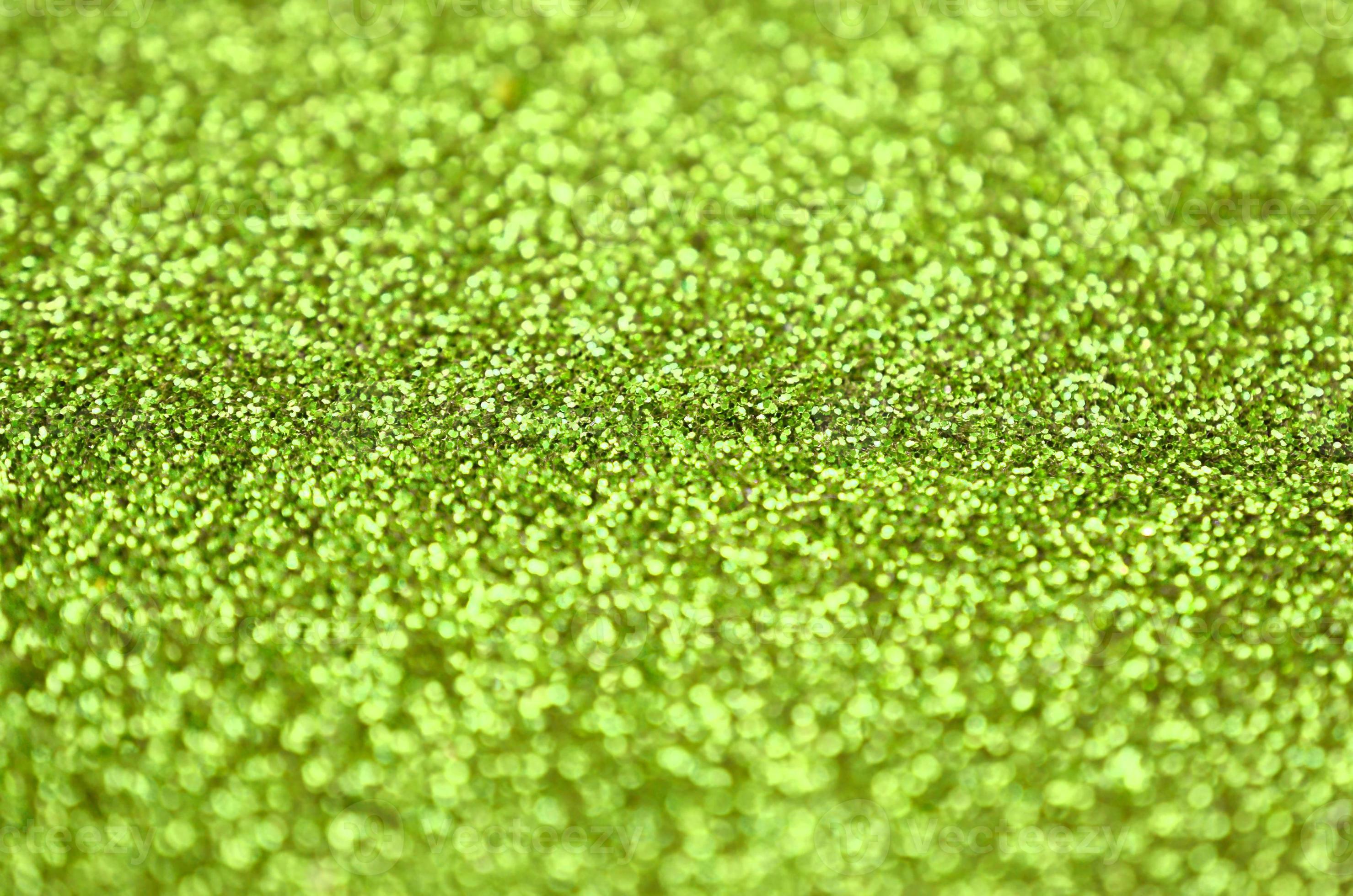 Lime green decorative sequins. Background image with shiny bokeh lights