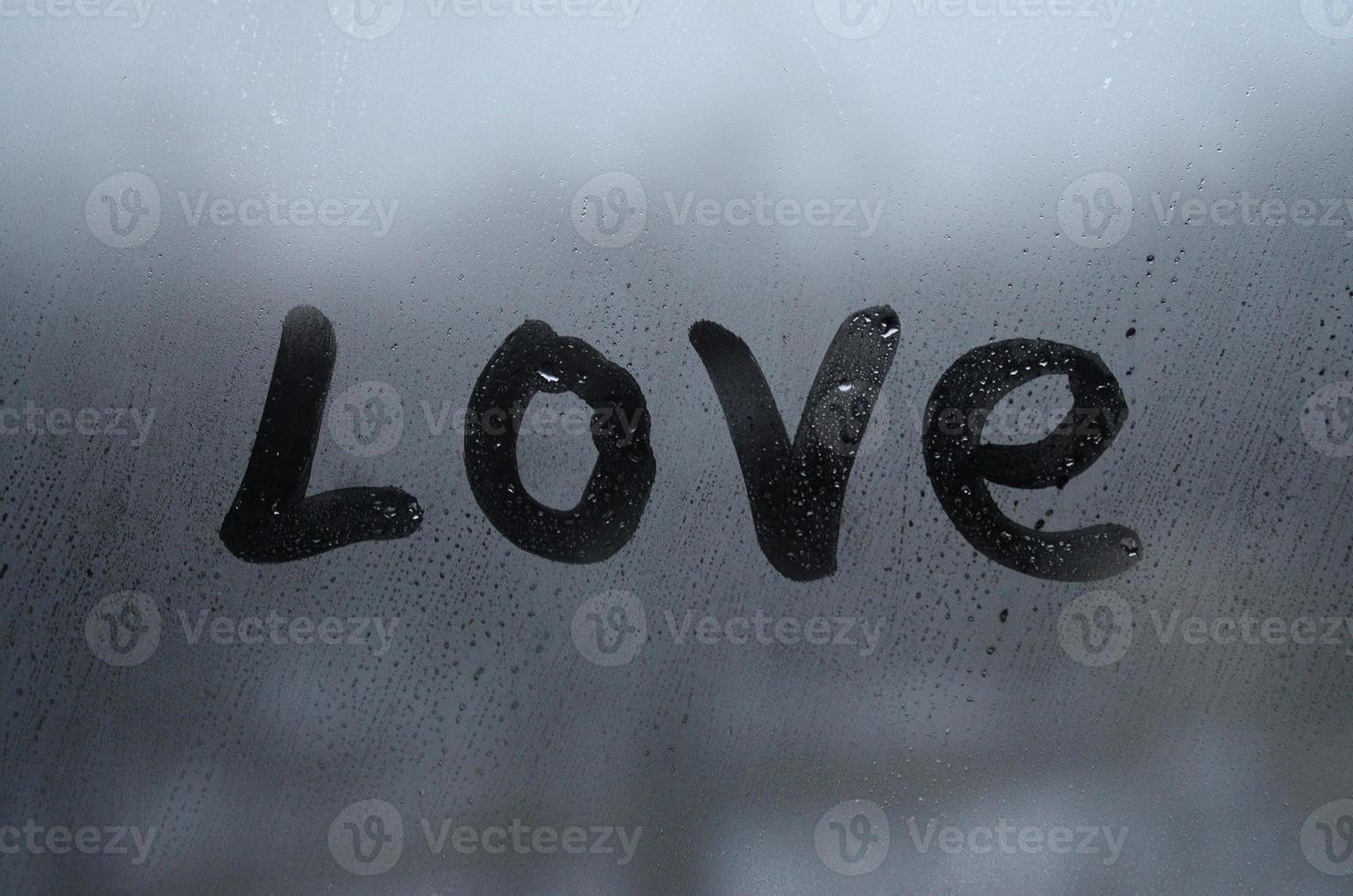 The English word love is written with a finger on the surface of the misted glass. United States of America photo
