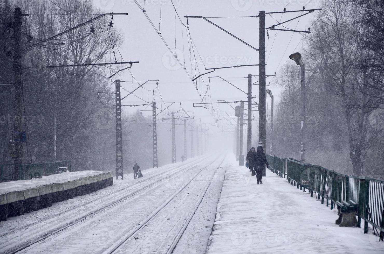 Railway station in the winter snowstorm photo