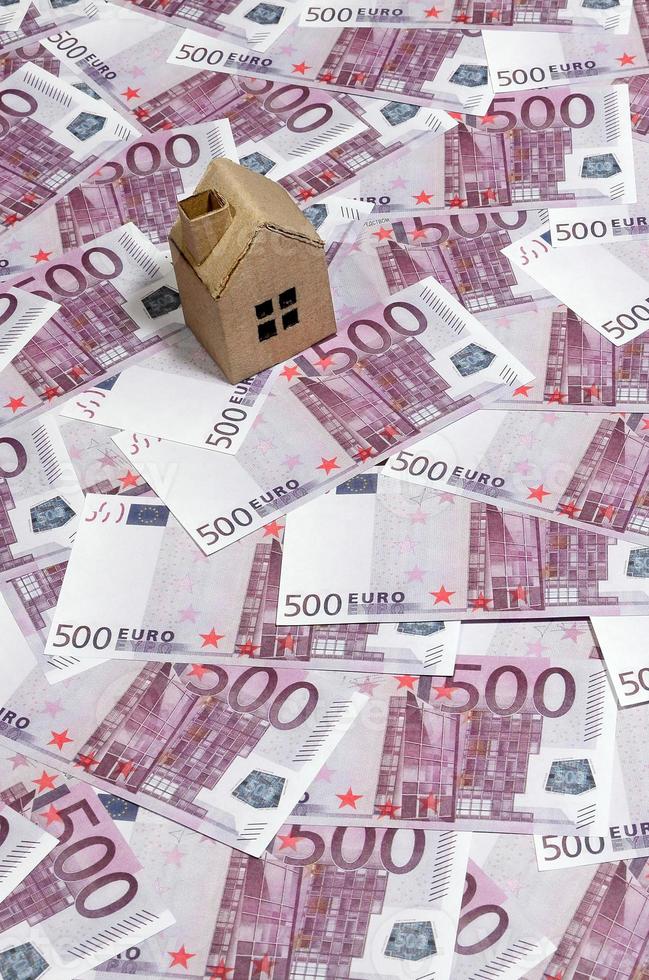 High Angle View Of A cardboard toy house On 500 Euro Notes. Money of euro for purchase of the private house. Mortgage concept photo