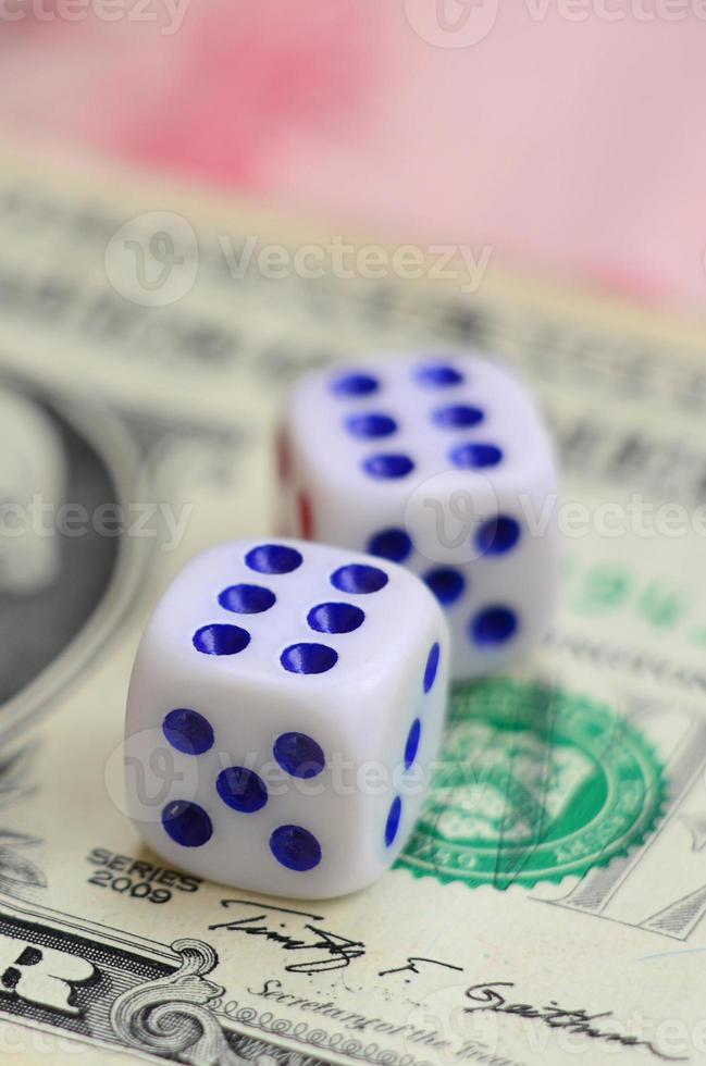 White dice are on a dollar bill of US dollars. The concept of gambling with rates in monetary units photo