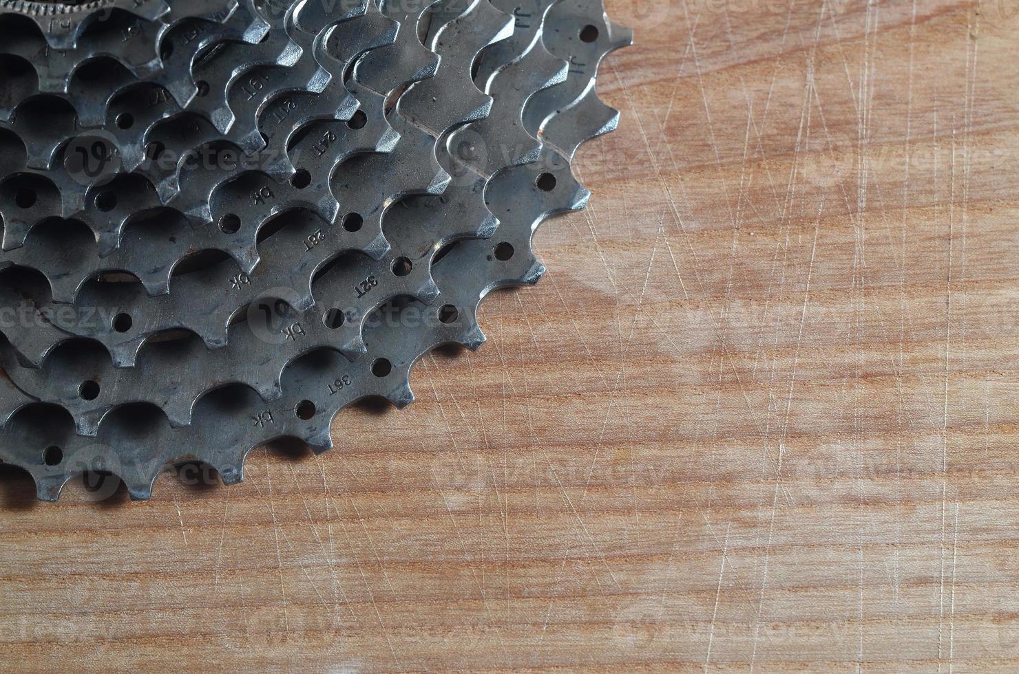 Rear cassette sprocket from a mountain bike lying on a wooden table in a bike shop photo