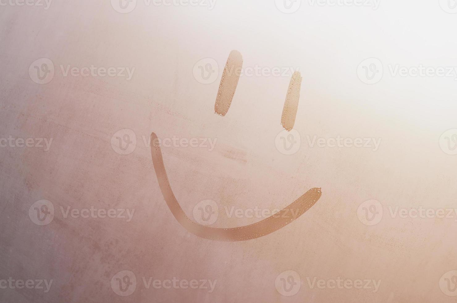 The inscription smile on the misted sweaty glass. Abstract background image photo