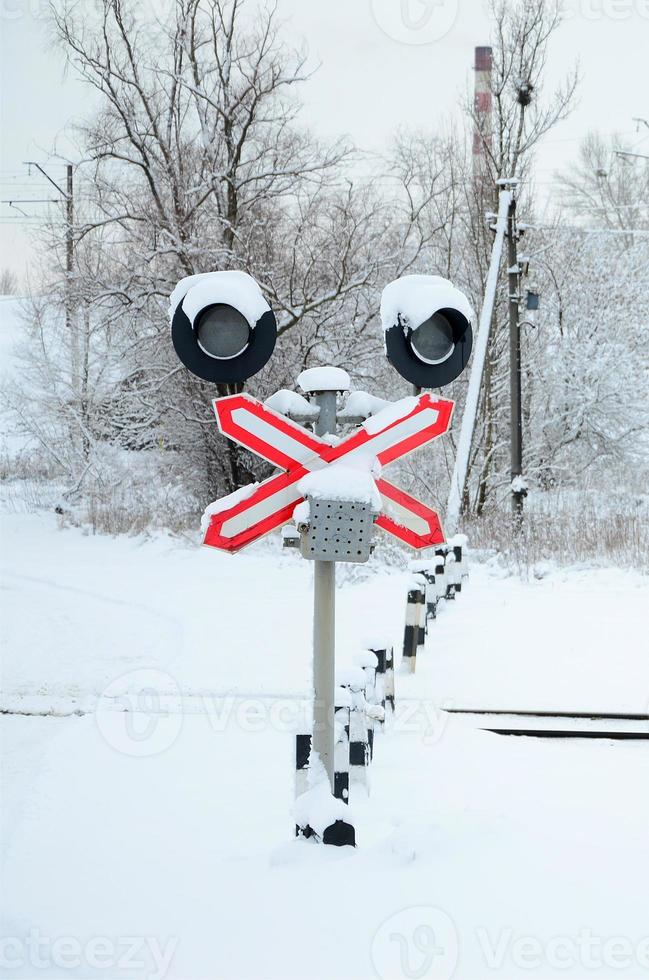 Semaphore is located on the motorway crossing the railway line in winter season photo