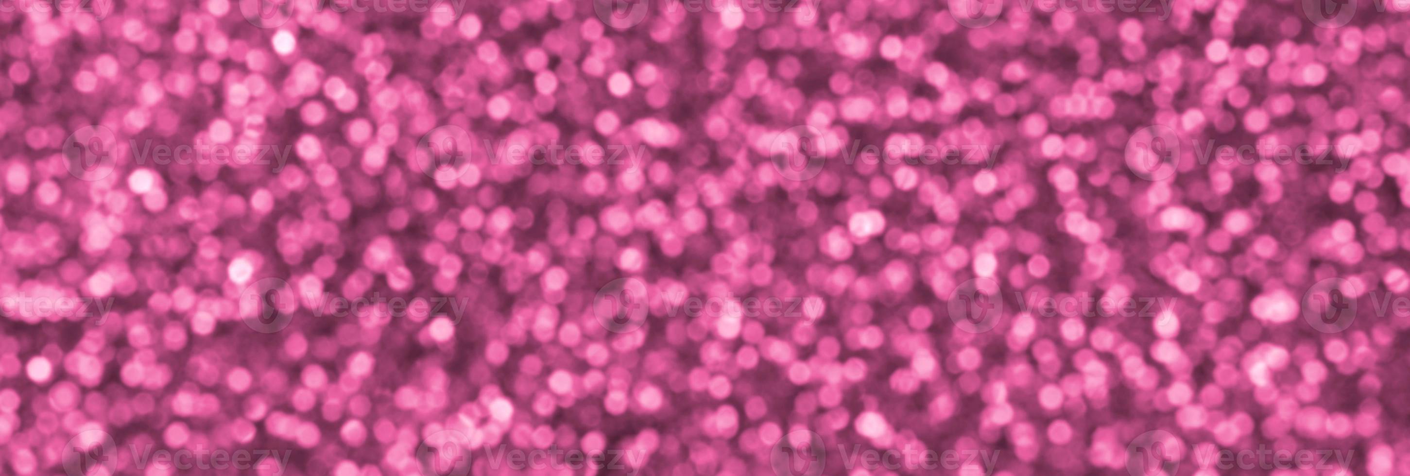 Blurred coral red decorative sequins. Background image with shiny bokeh lights from small elements photo