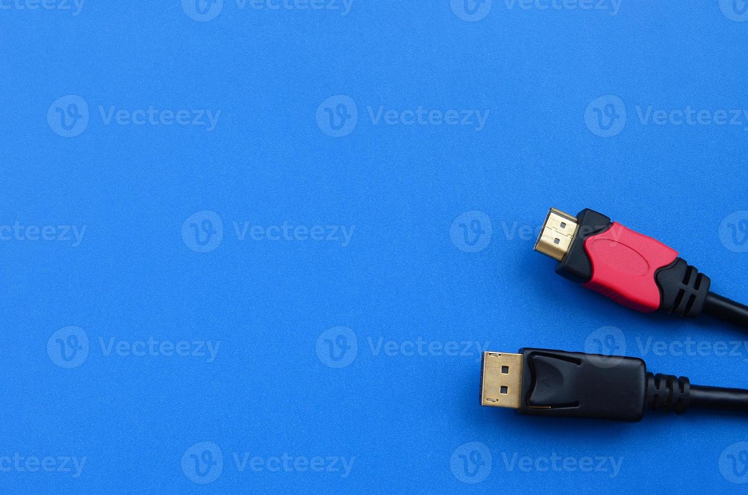 Audio video HDMI computer cable plug and 20-pin male DisplayPort gold plated connector for a flawless connection on a blue background photo