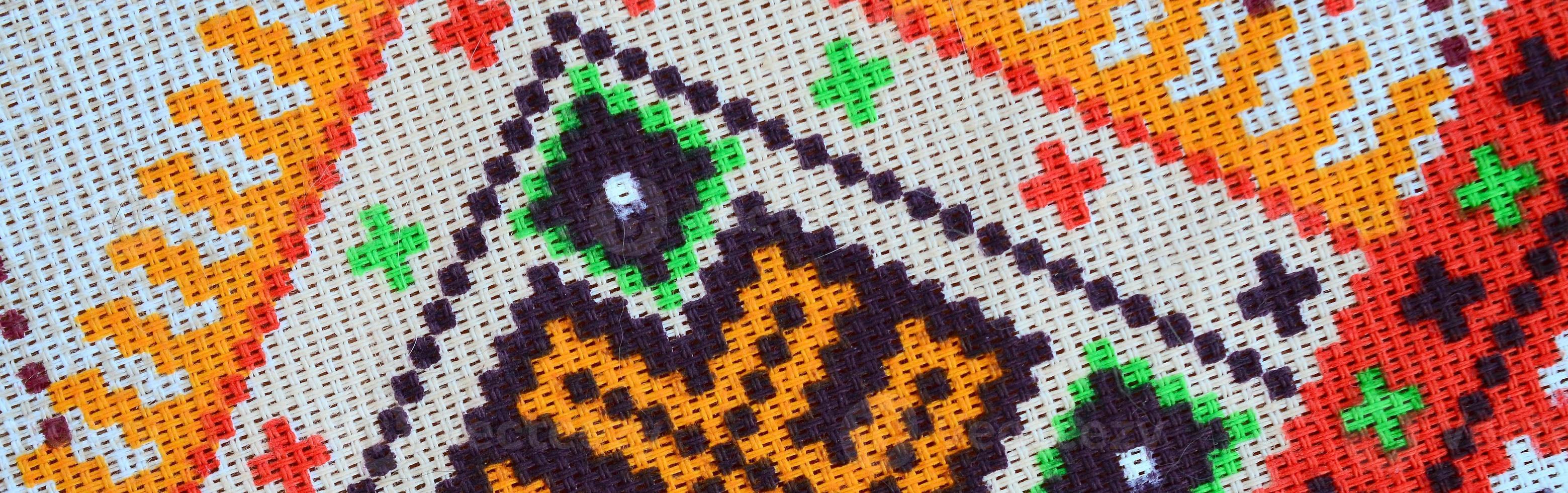 Traditional Ukrainian folk art knitted embroidery pattern on textile fabric photo