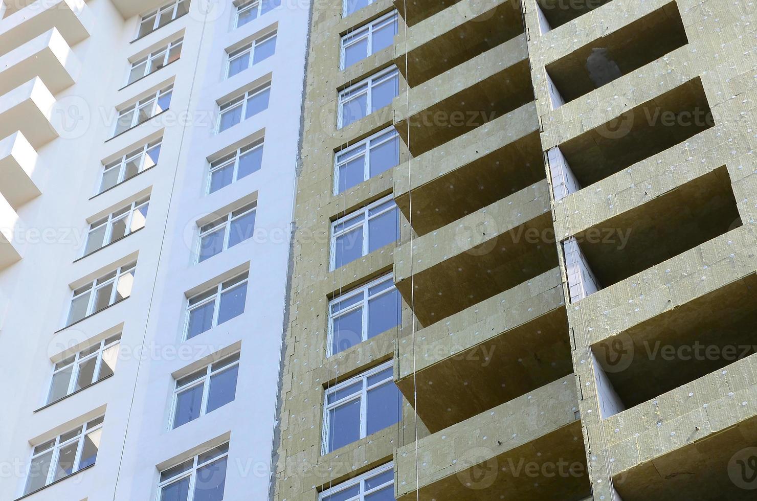 Residential multi store apartement building house facade under construction photo