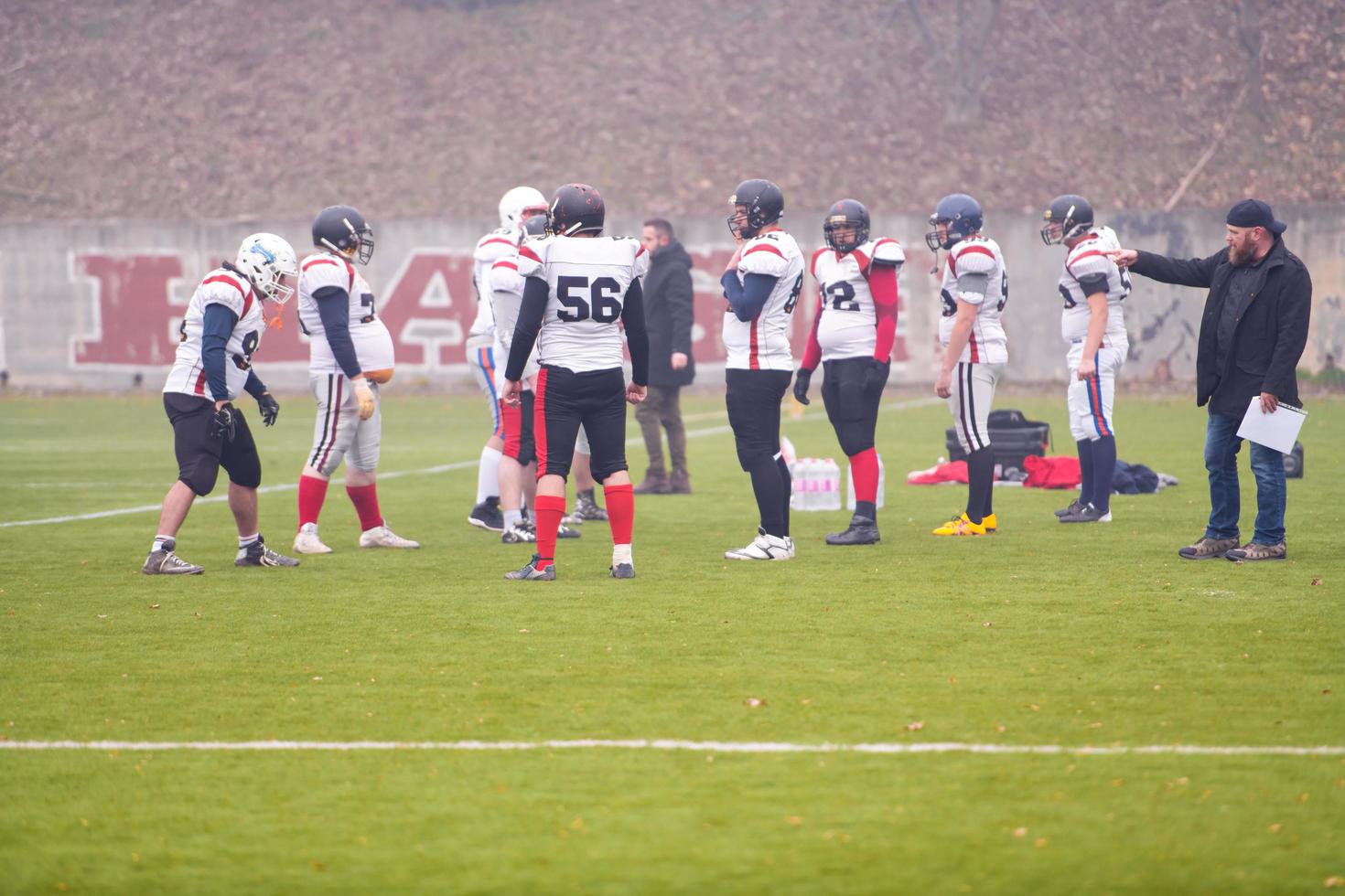 american football players discussing strategy with coach photo