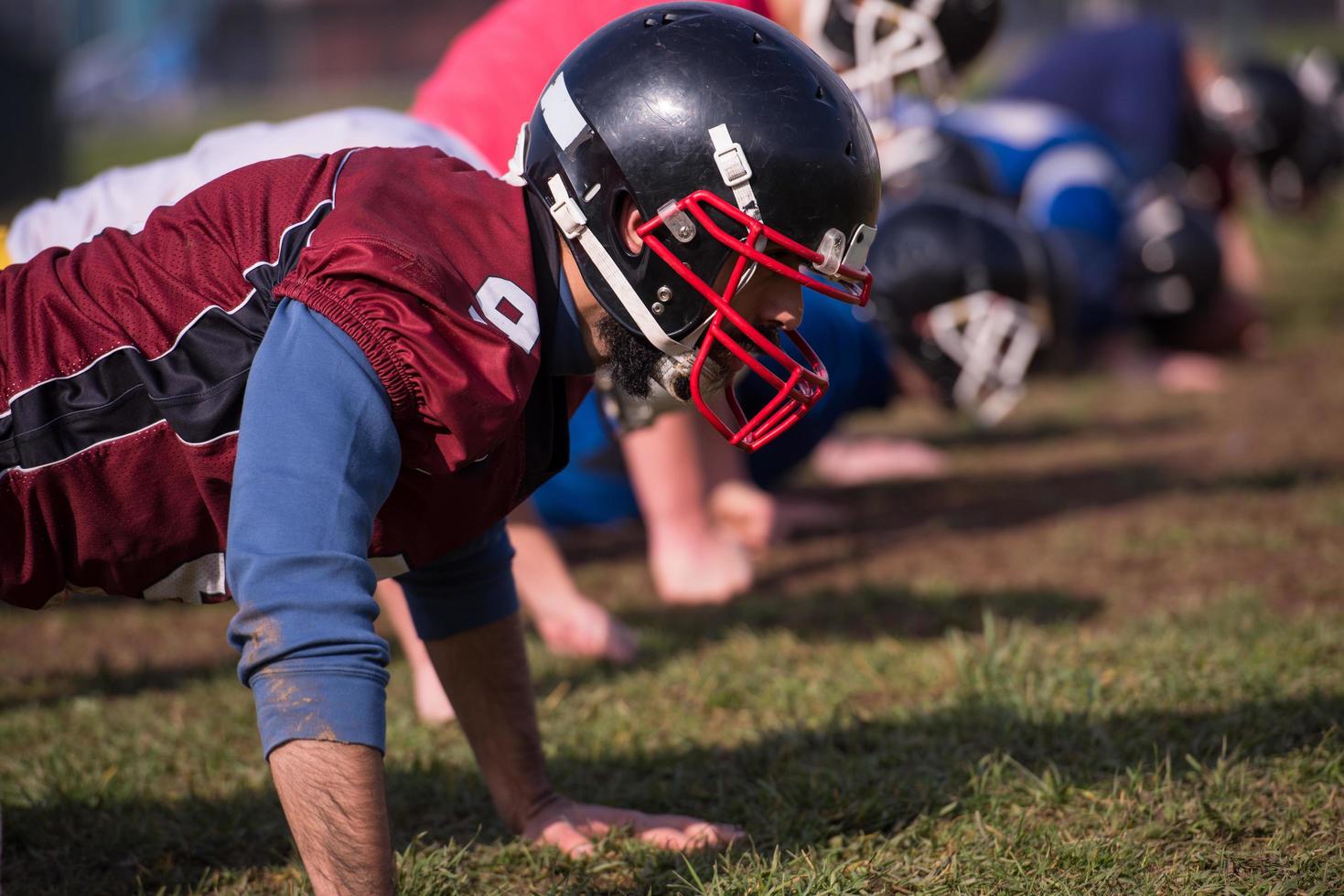 american football team doing push ups photo