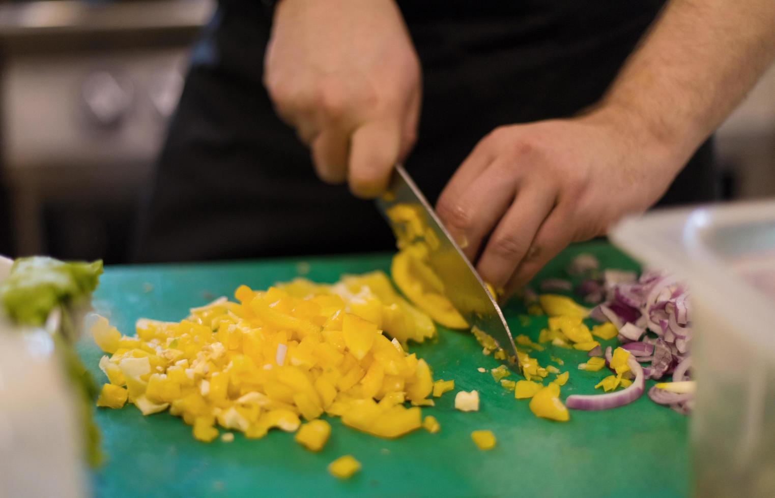 Chef cutting fresh and delicious vegetables photo