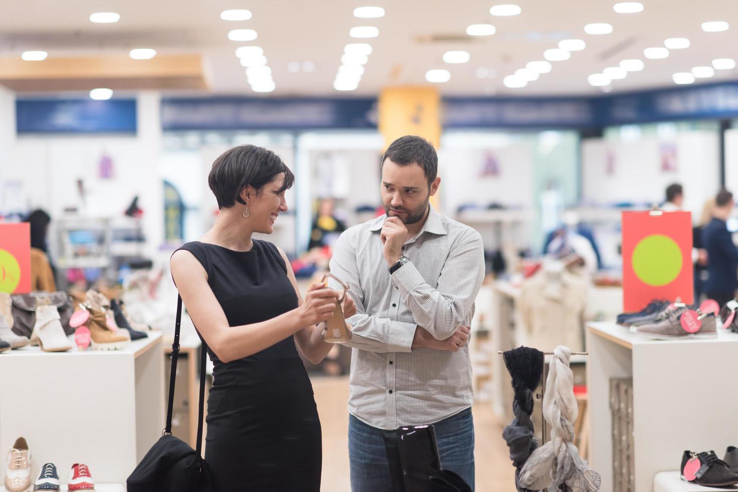 couple chooses shoes At Shoe Store photo