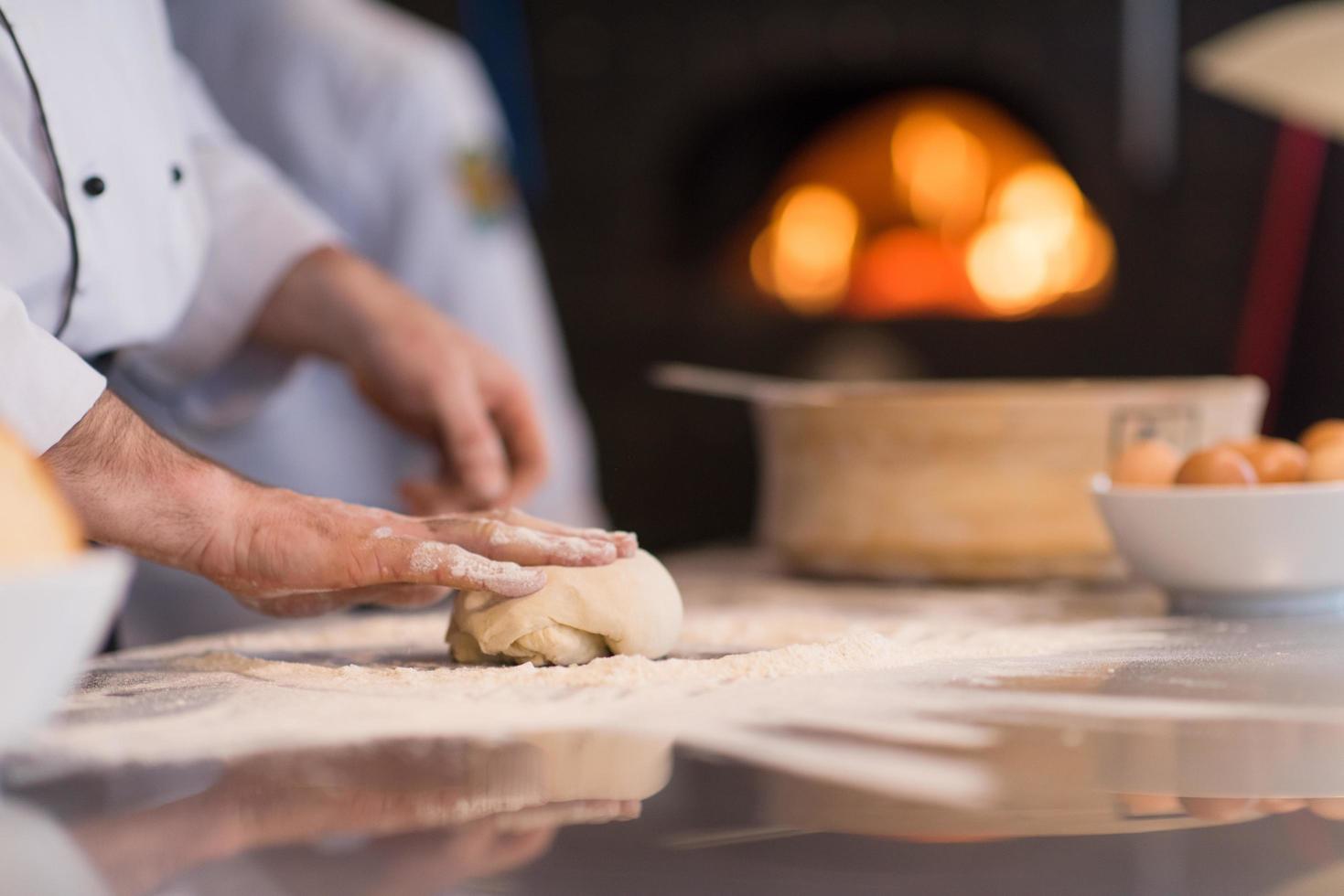 chef hands preparing dough for pizza photo