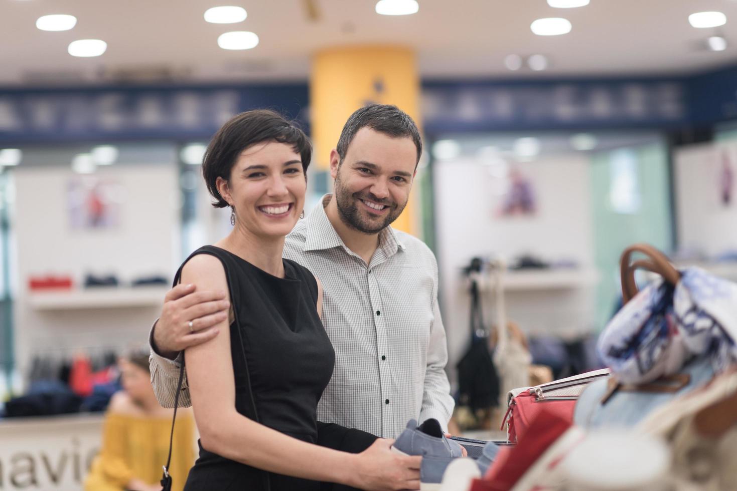 couple chooses shoes At Shoe Store photo