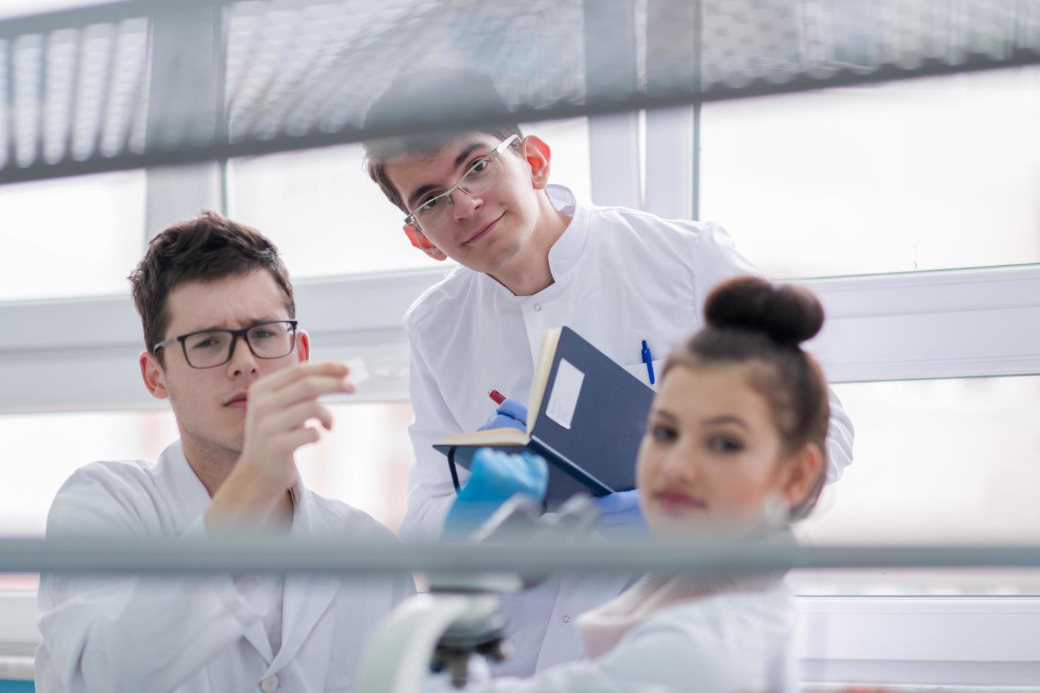 Group of young medical students doing research photo