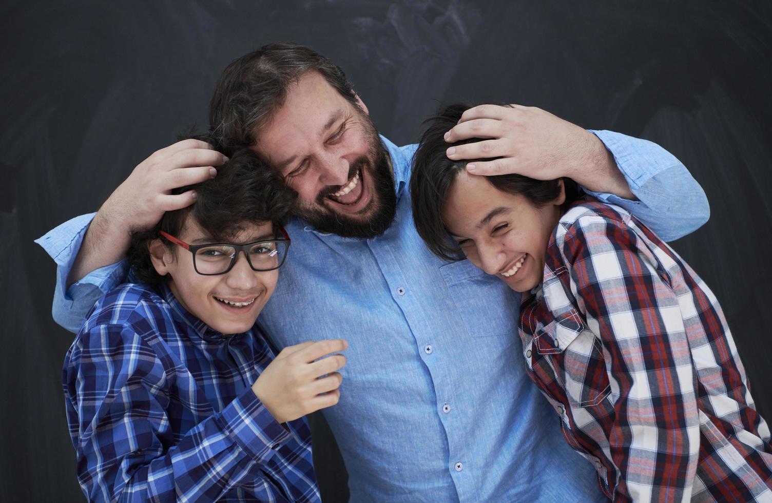 happy father hugging sons photo