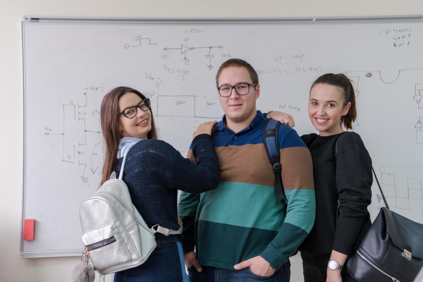 portrait of young students in front of chalkboard photo