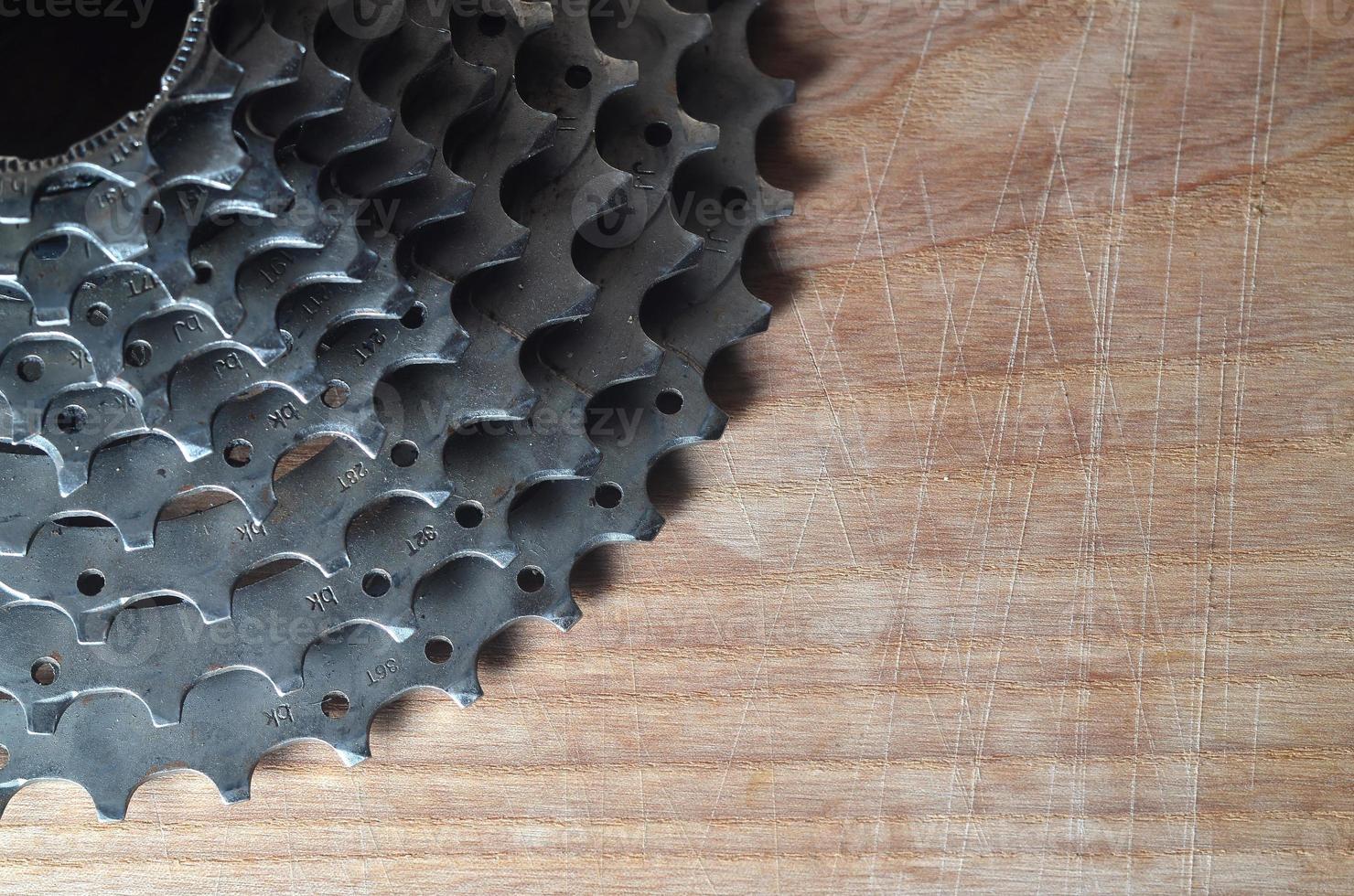 Rear cassette sprocket from a mountain bike lying on a wooden table in a bike shop photo
