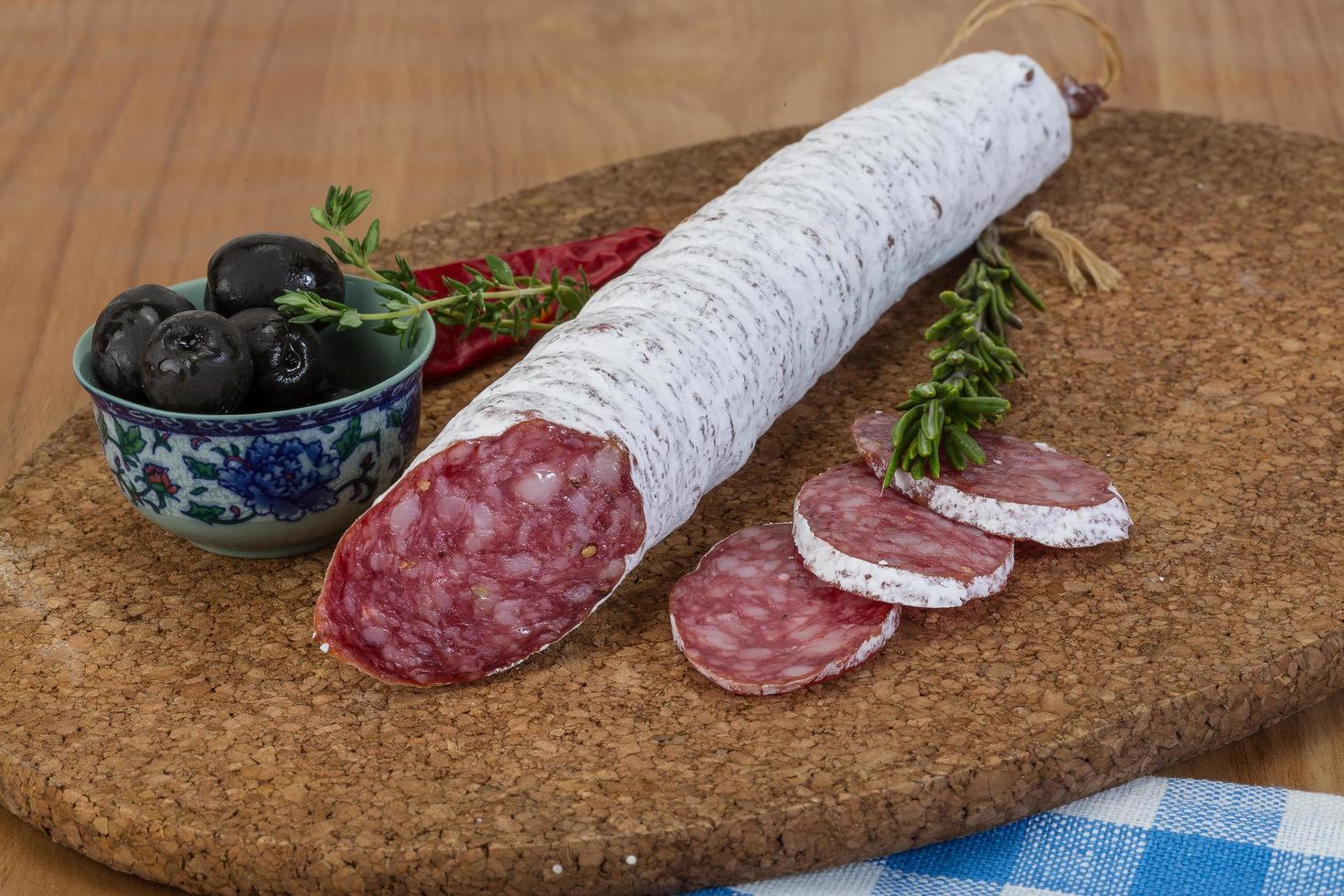 Fuet sausage on wood photo