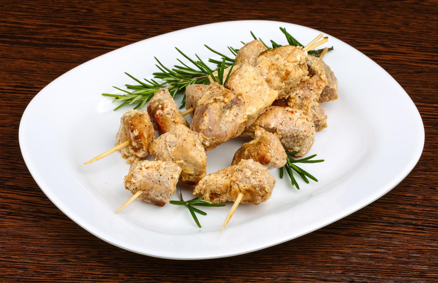 Chicken skewers on plate photo
