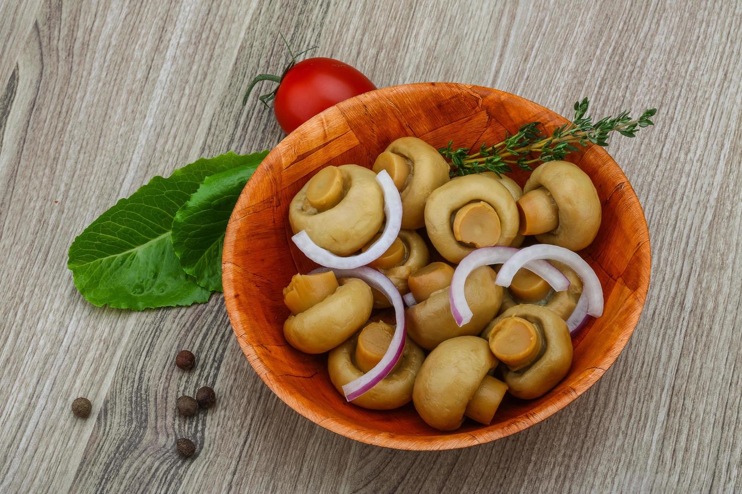 Pickled champignon on wood photo