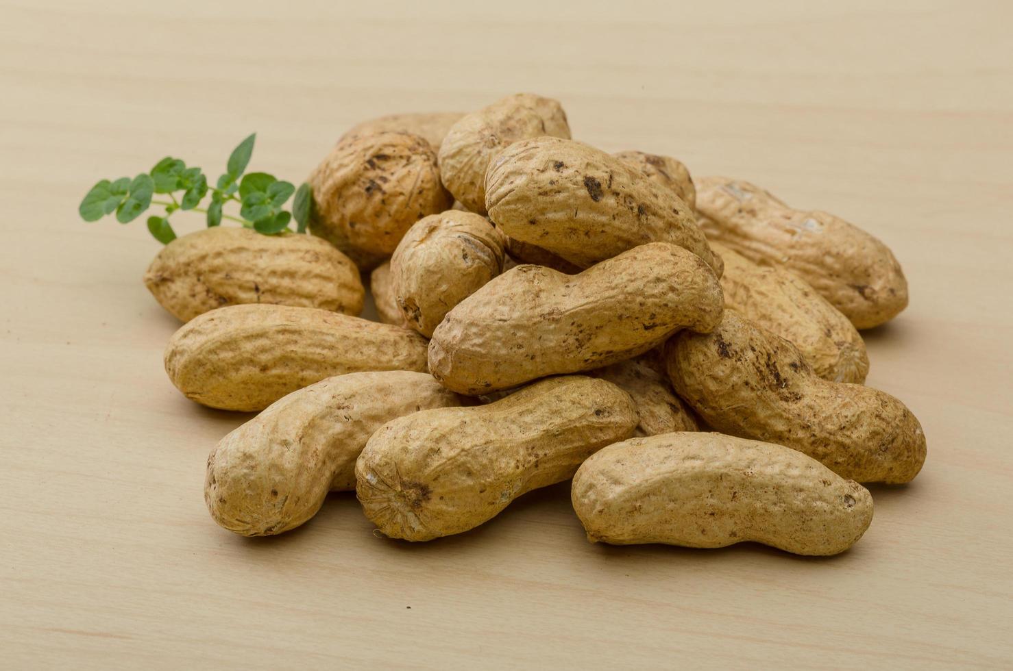 Raw peanuts on wood photo