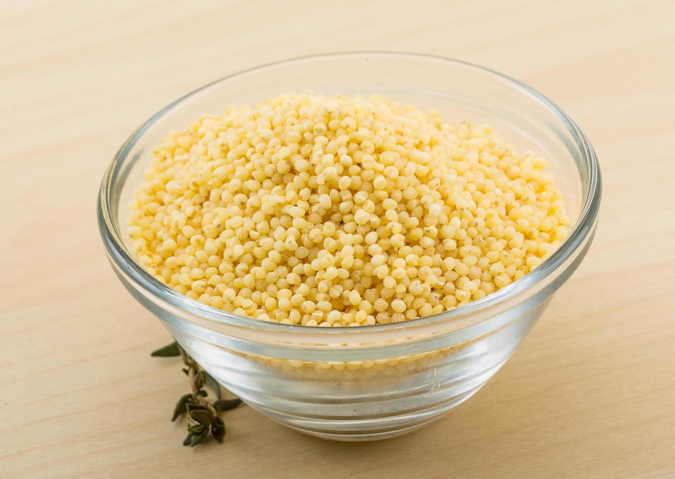 Dry couscous on wood photo