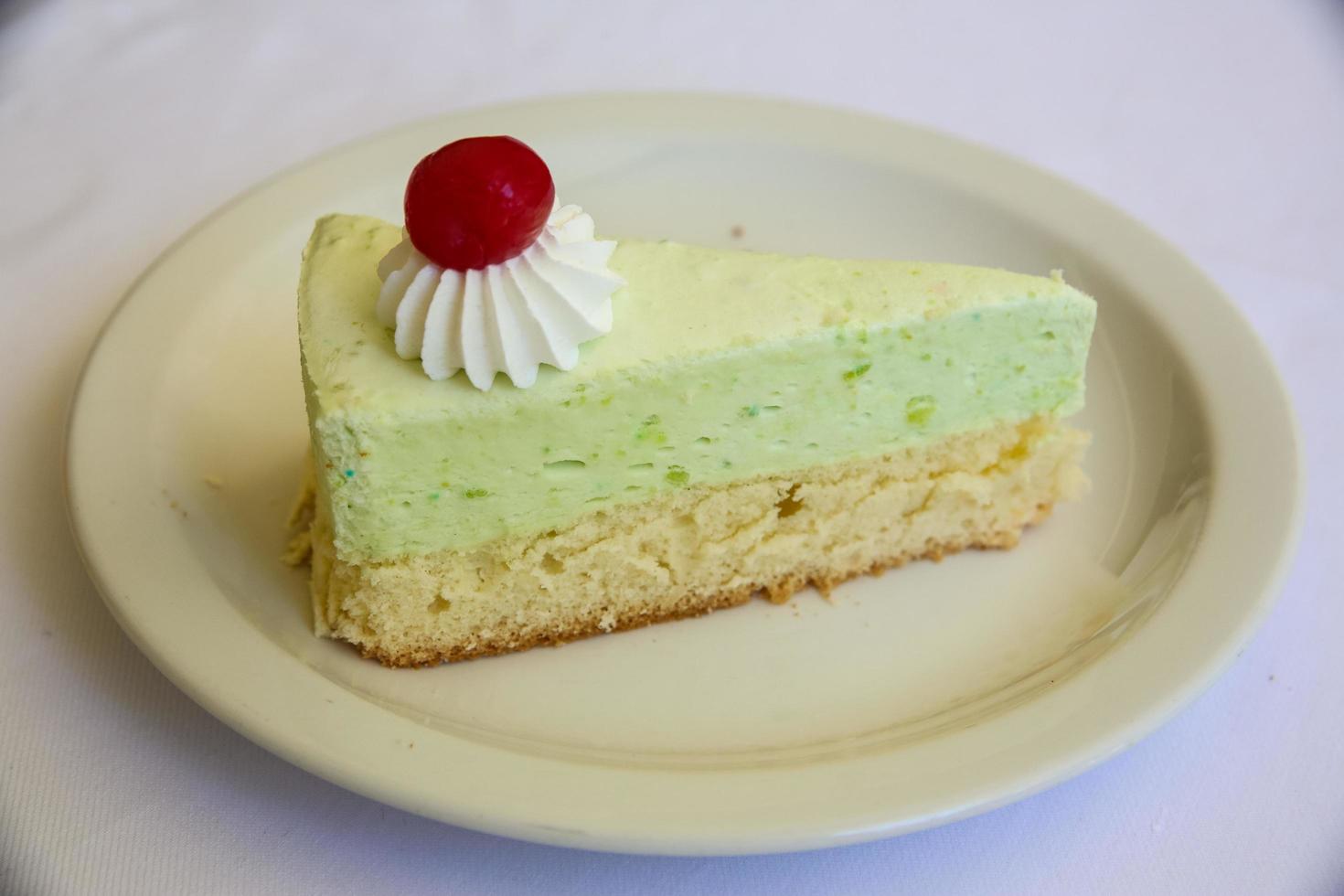 Pistachio cheesecake on white background photo