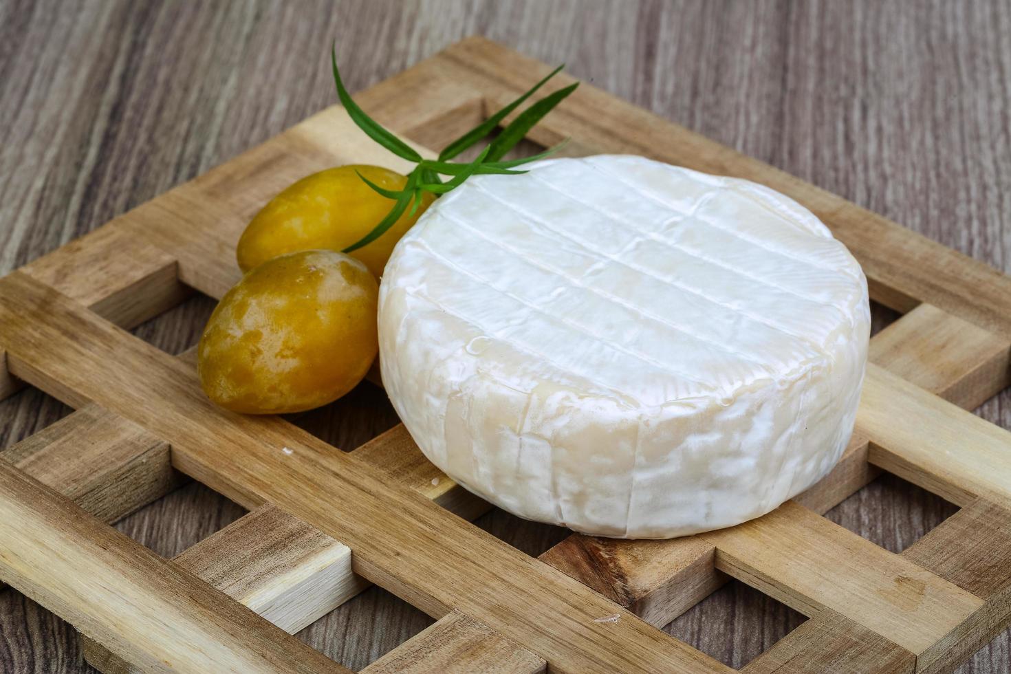 Brie cheese on wood photo