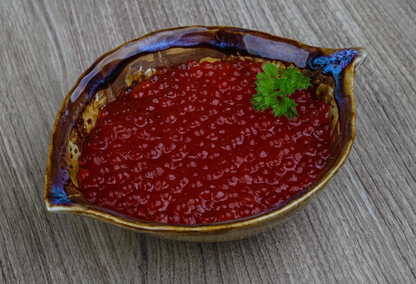 Red caviar on wood photo