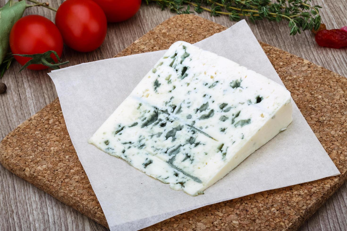 Blue cheese on wooden board and wooden background photo