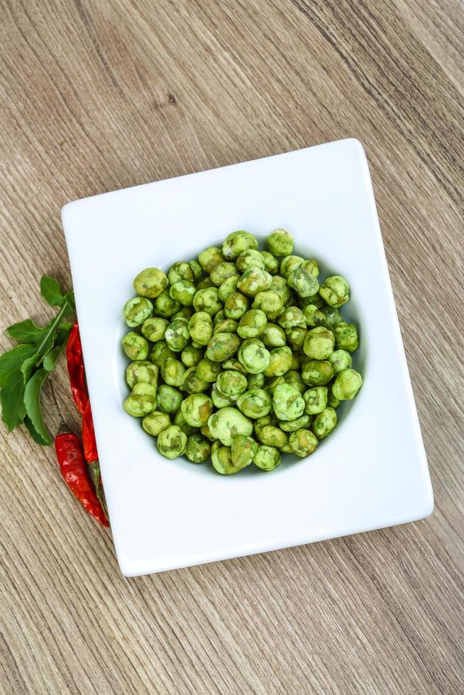 Wasabi peas on wood photo