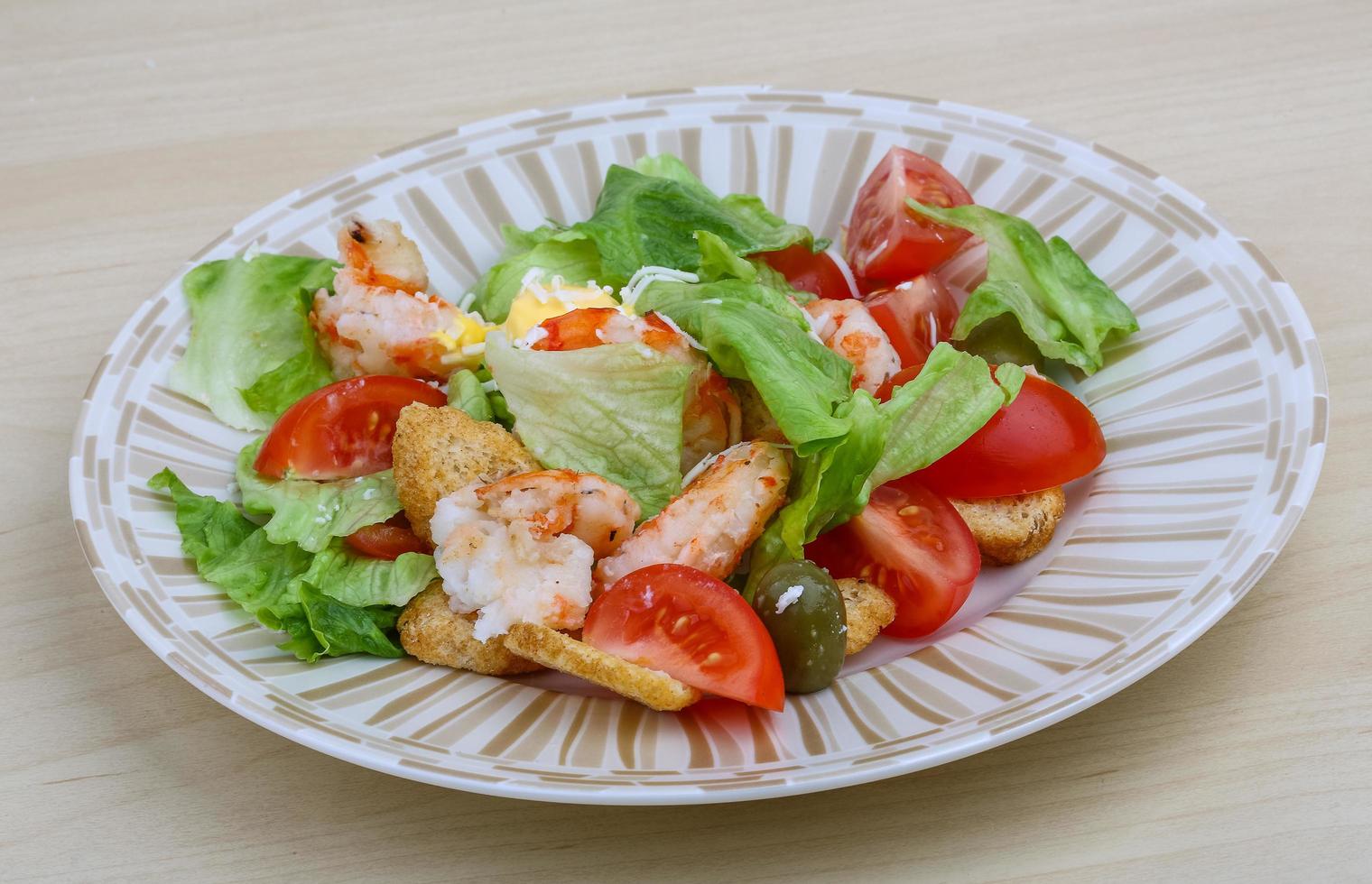 Caesar salad on wood photo