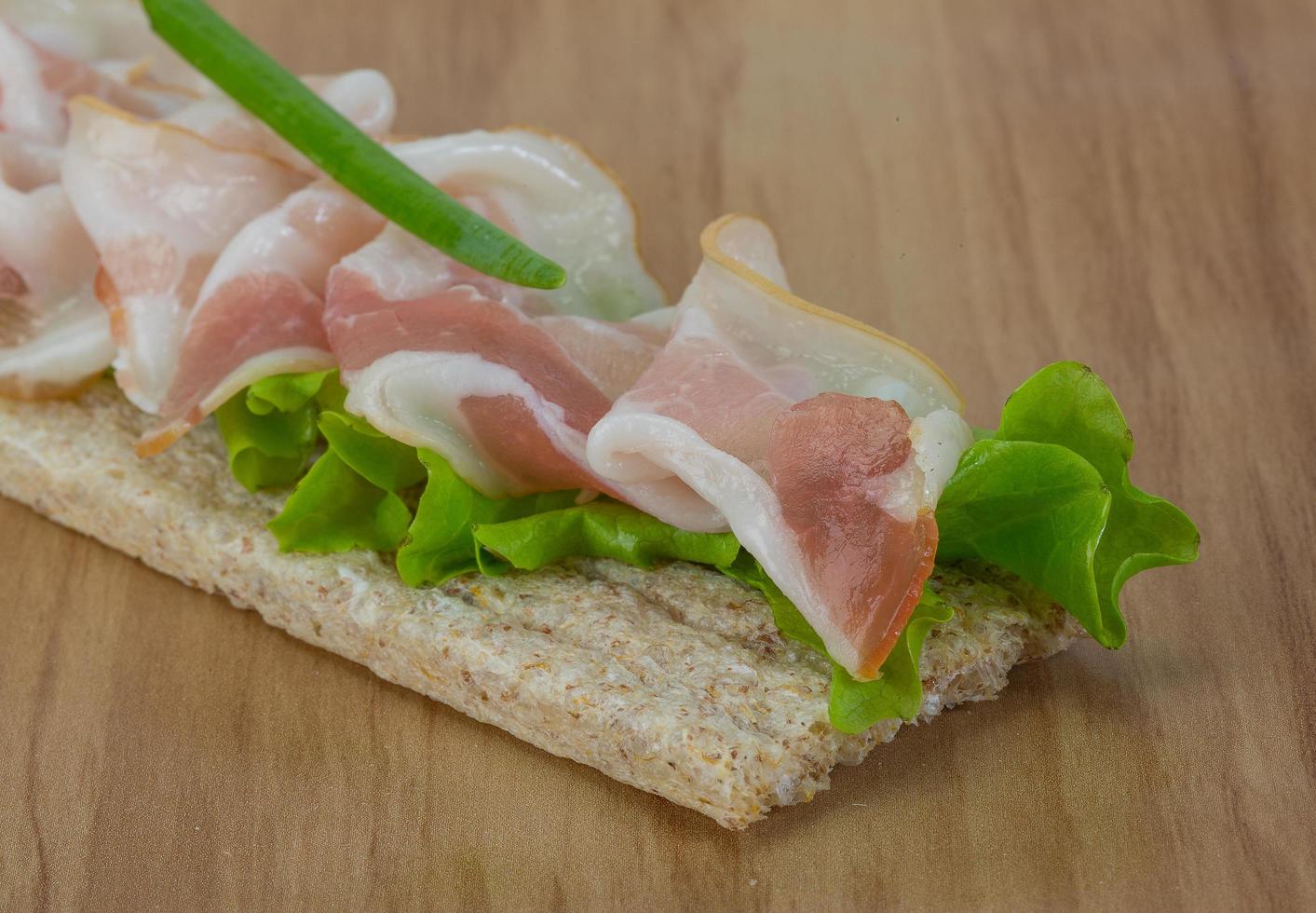 Bacon sandwich on wood photo
