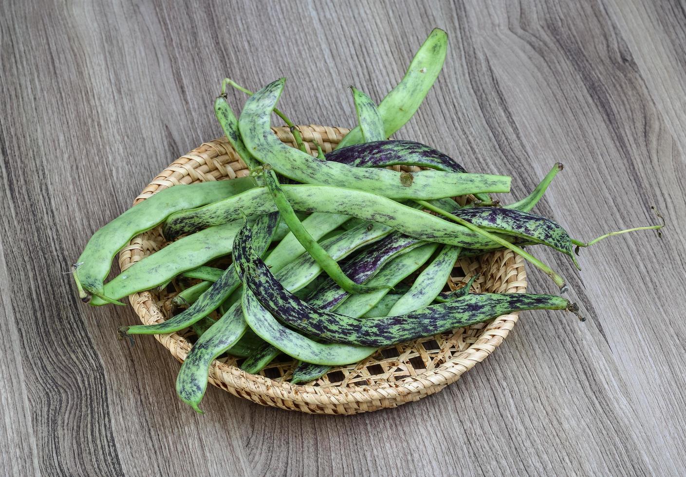 Green beans on wood photo