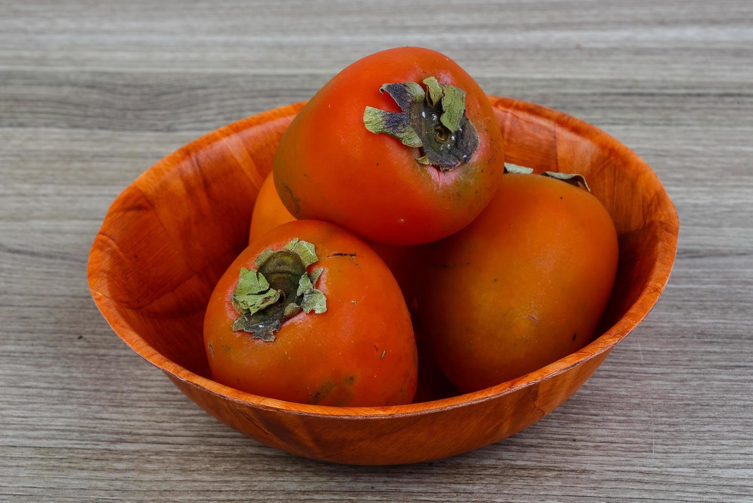 Persimmon on wood photo