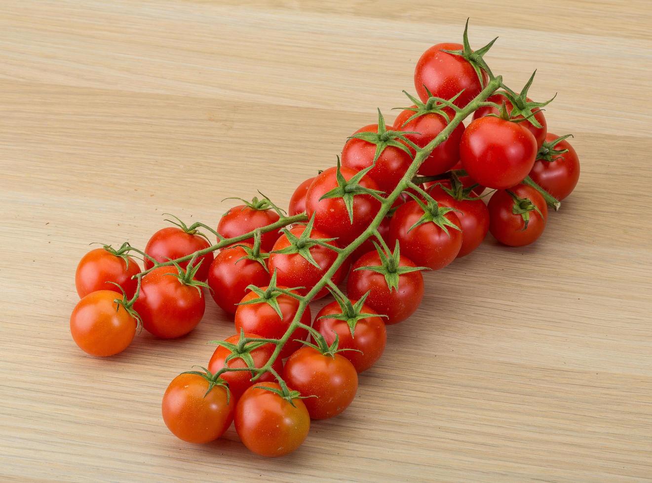 Cherry tomatoes on wood photo