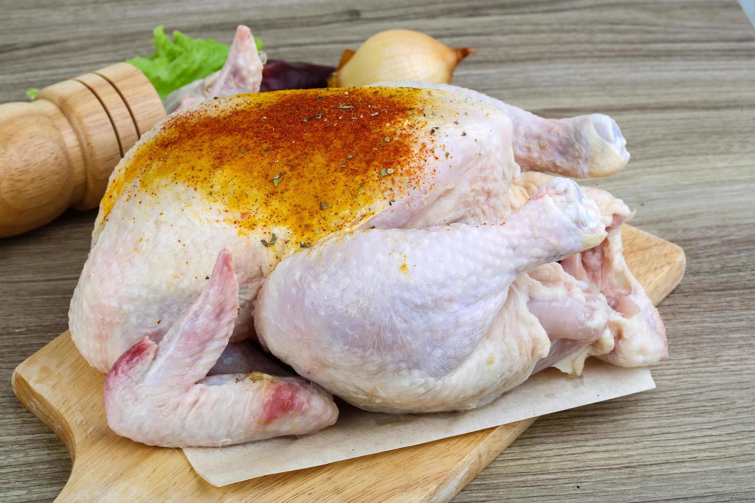 Raw chicken on wood photo