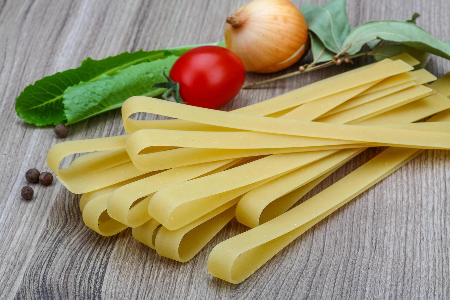 Fettuccine on wooden background photo