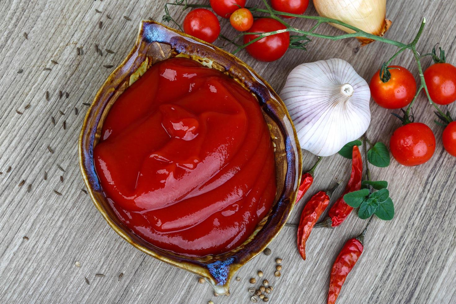 Tomato ketchup on wood photo